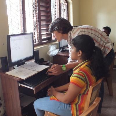 An IT volunteer teaching a young girl how to use the computer in Sri Lanka A students learns to use the computer at one of our Projects Abroad volunteer IT teaching placements in Sri Lanka